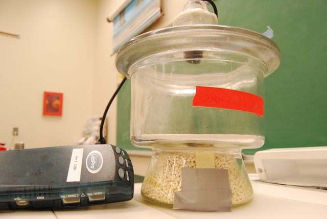Clear dessicator jar attached to operation apparatus.